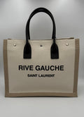 Sac cabas moyen Saint Laurent Rive Gauche en cuir noir avec logo emblématique sur le devant.