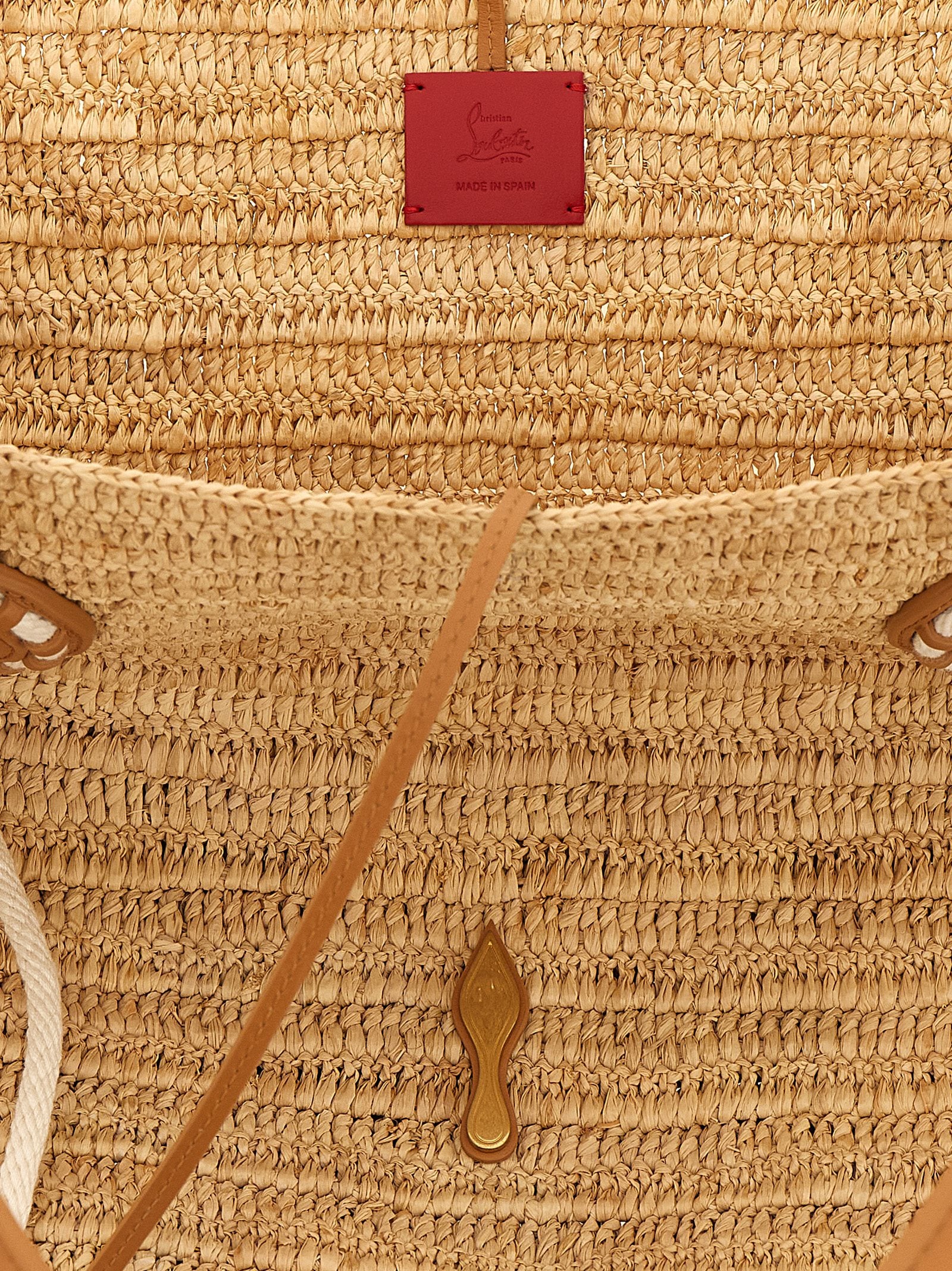 Sac à poignée en raphia beige de Christian Louboutin avec logo distinctif et détails élégants.