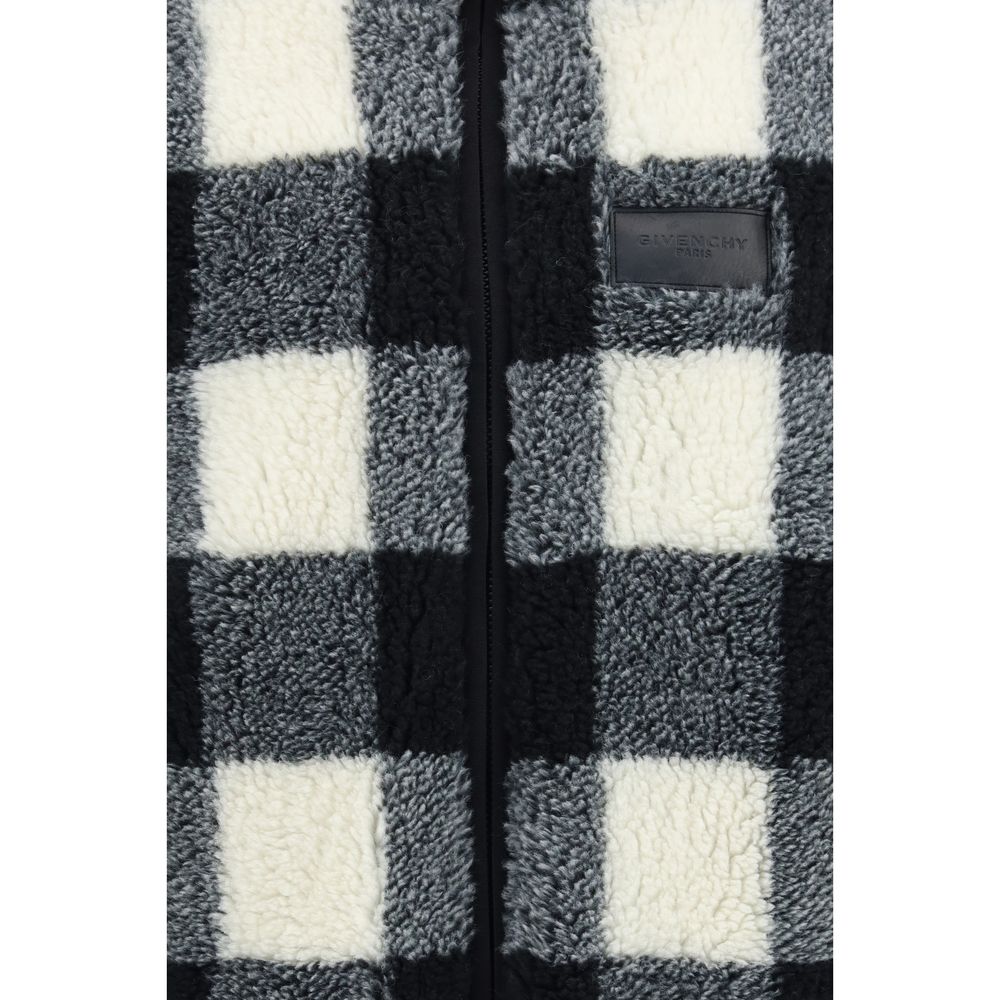 Veste longue en polyester gris de la marque Givenchy, visible devant avec détails de couture et fermeture éclair.