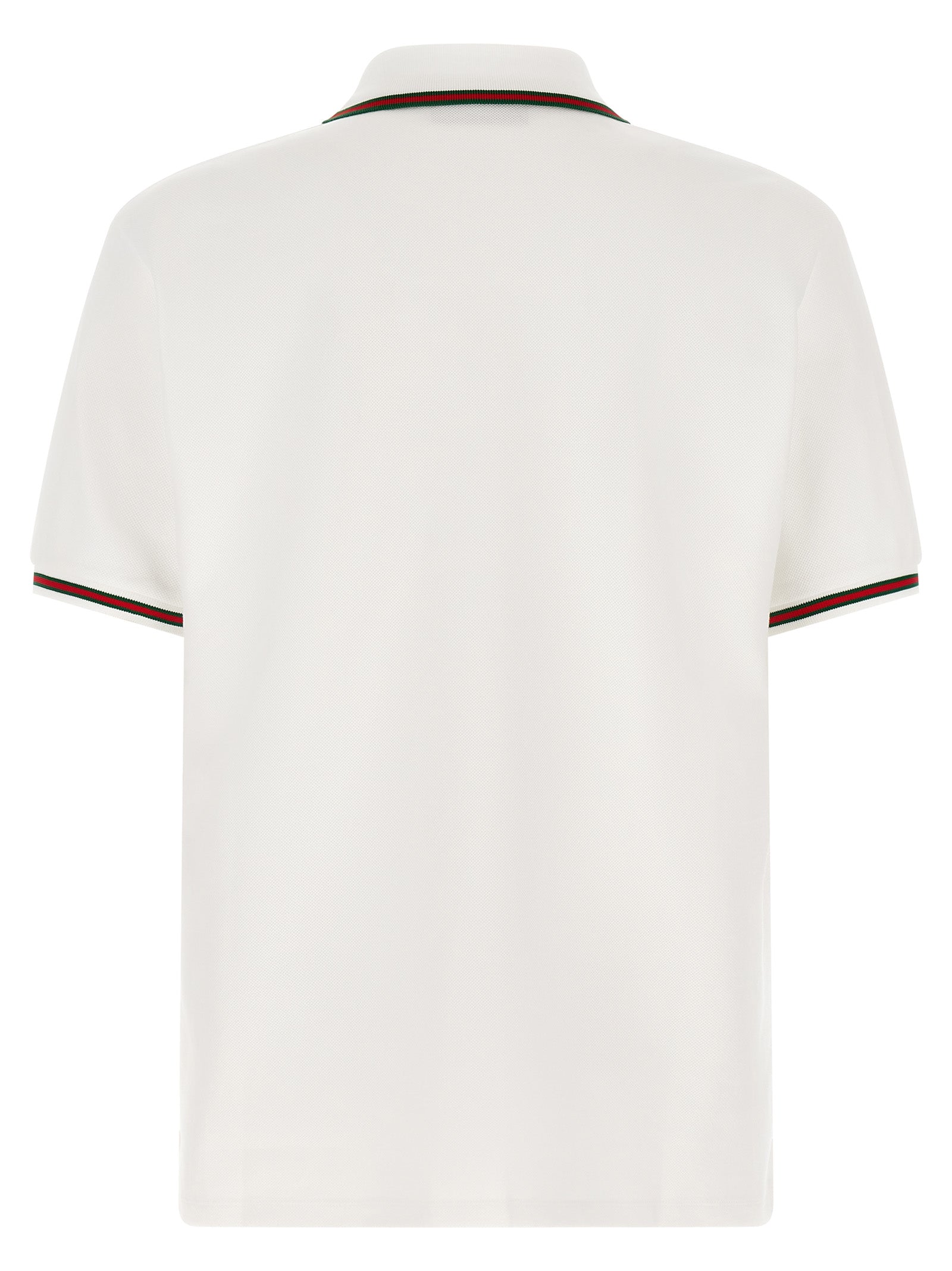 Chemise polo blanche en coton de Gucci avec logo discret, portée sur un mannequin.