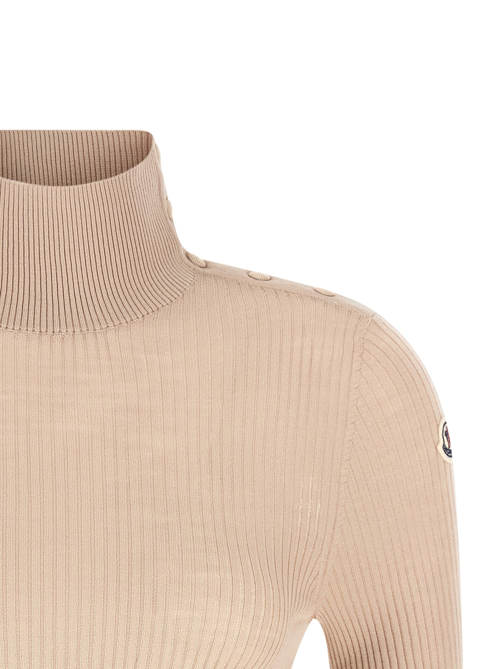 Cardigan beige en laine vierge de la marque Moncler, détails du tissu et coupe élégante visible dans l’image.