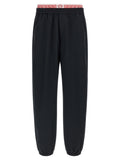 Pantalons de sport noirs Versace en polyamide, joggers élégants pour l'entraînement et le confort.