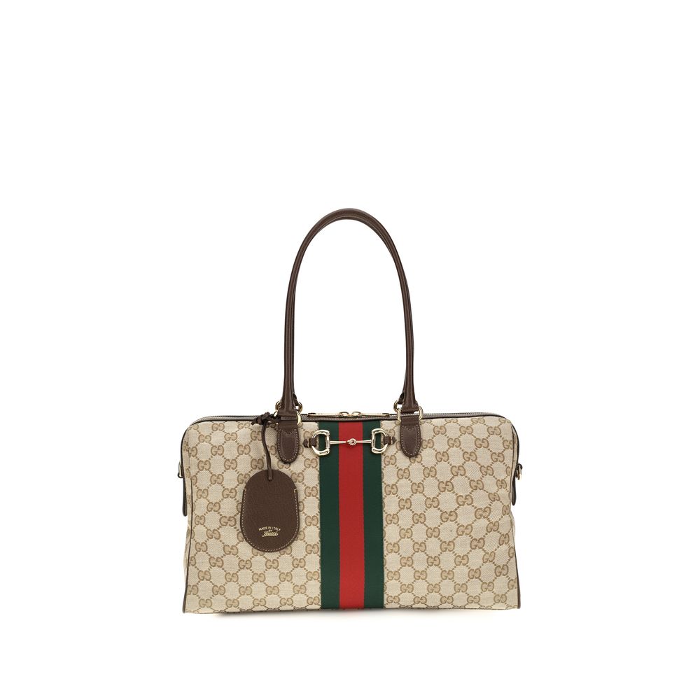 Sac à main en tissu beige Gucci, élégant et sophistiqué, avec détails de la marque, idéal pour un style chic et moderne.