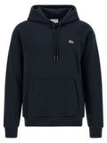 Sweat-shirt en coton bleu Lacoste avec logo crocodile, manches longues et coupe classique, porté sur un mannequin.