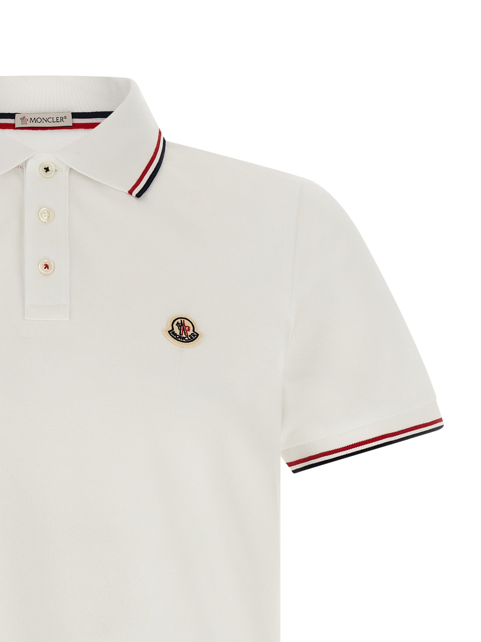 Chemise polo blanche en coton Moncler, vue de face, avec col classique et logo discret sur la poitrine.