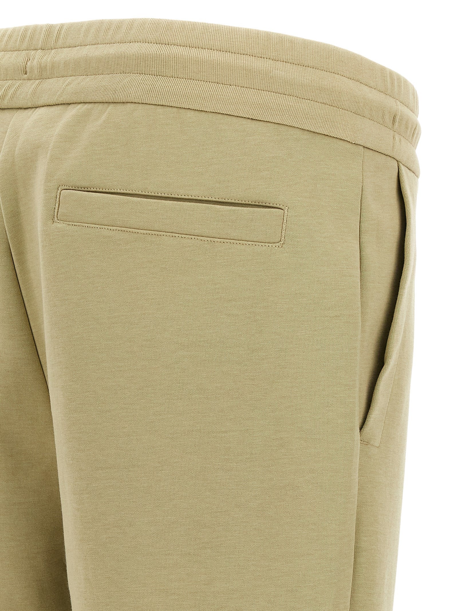 Pantalons de jogging en coton beige Hugo Boss pour entraînement, avec taille élastique et poches latérales.