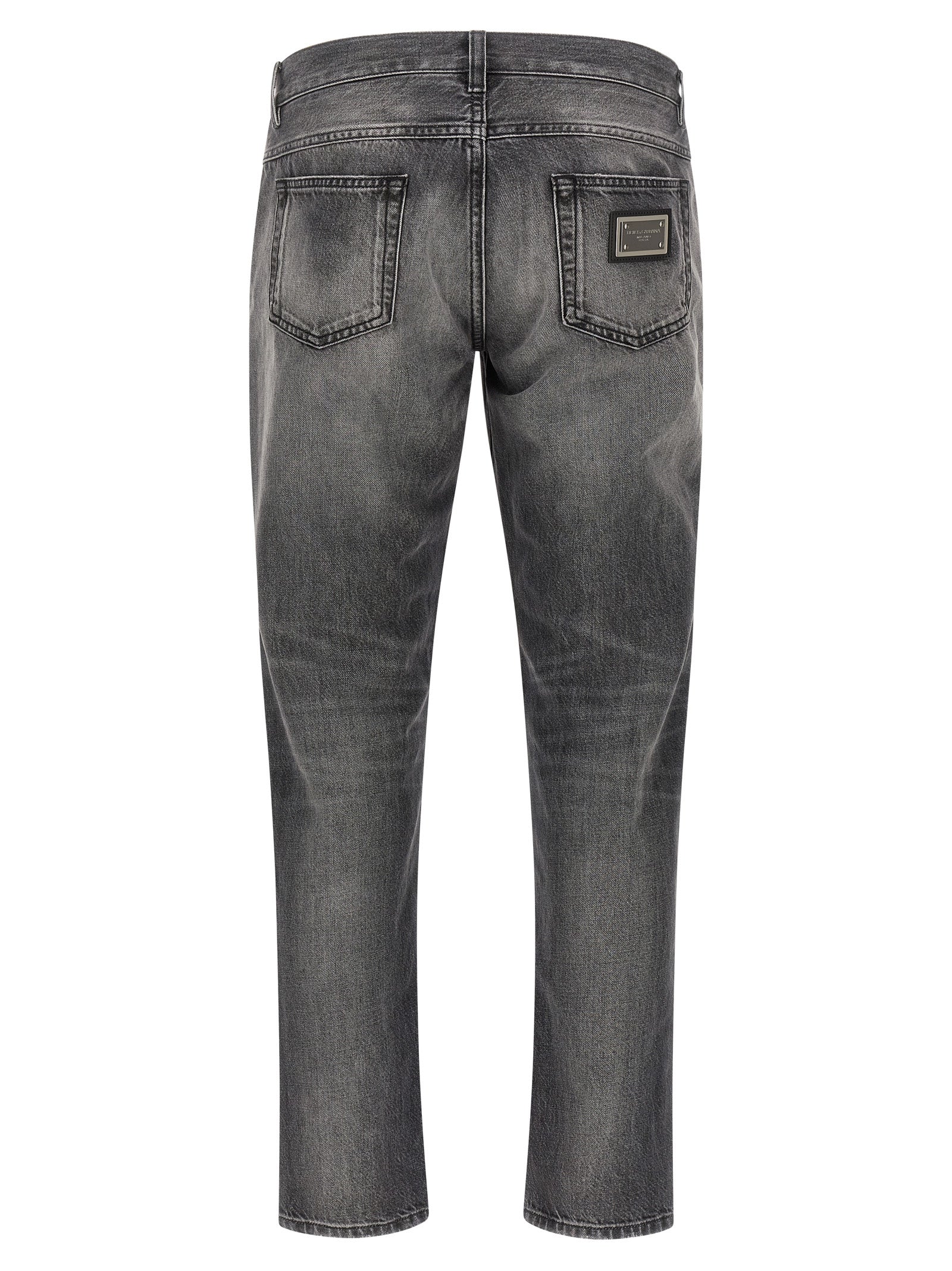 Jeans en denim gris Dolce & Gabbana en coton, coupe classique et détails authentiques, sur un fond neutre.