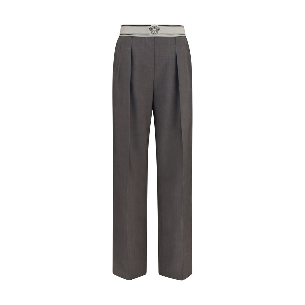 Pantalons gris en laine Versace Oves Aries avec logo, coupe élégante et détails sophistiqués, visibles sur l'image.