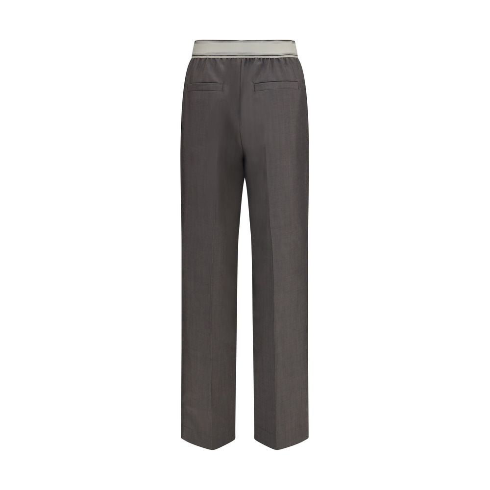 Pantalons gris en laine Versace Oves Aries avec détails élégants, visibles en gros plan sur l'image.
