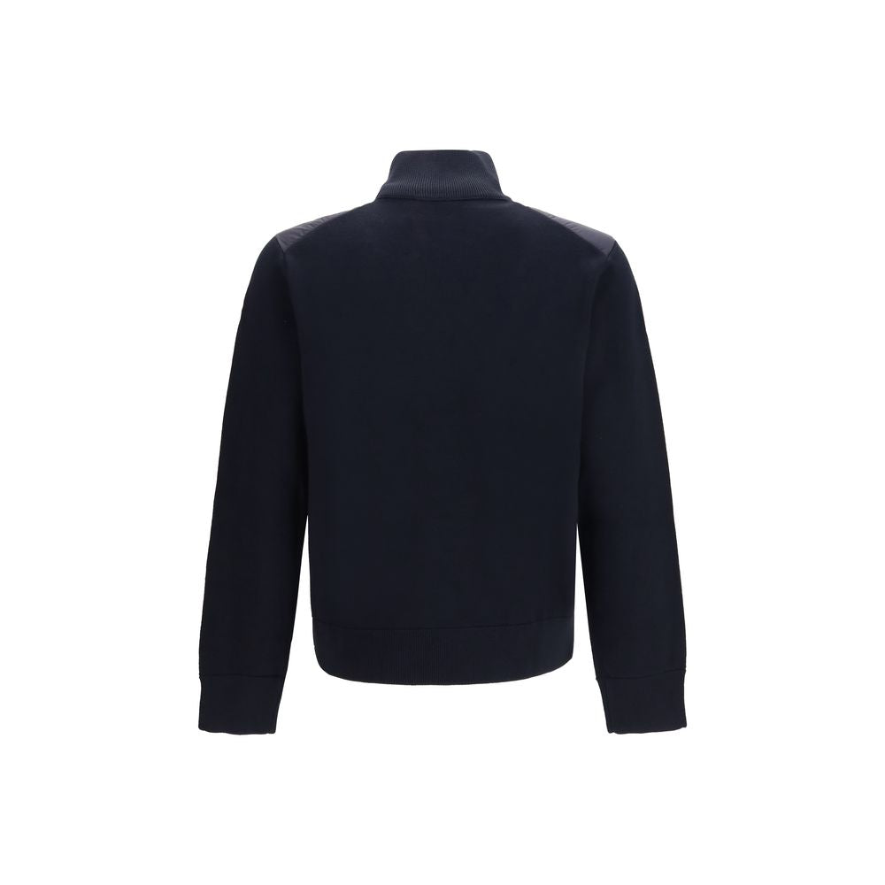 Veste longue en duvet bleu Moncler Goose Down, coupe élégante, avec capuche et fermeture éclair, pour homme ou femme.