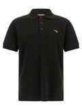 Chemise polo noire en coton de la marque Kenzo, avec col et boutons, visible sur une mannequin.