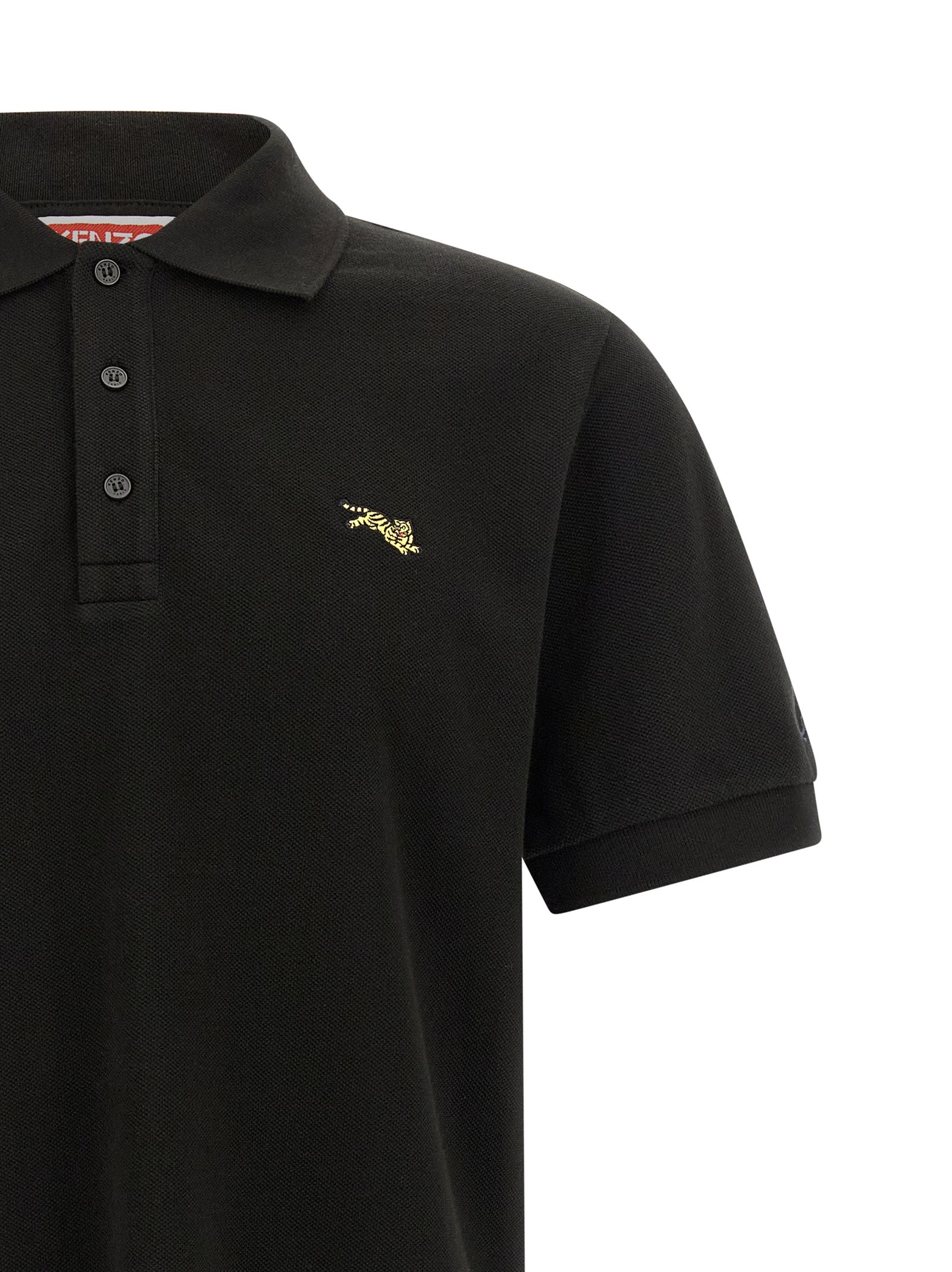 Chemise polo noire en coton de la marque Kenzo, vue de face avec col et boutons visibles.