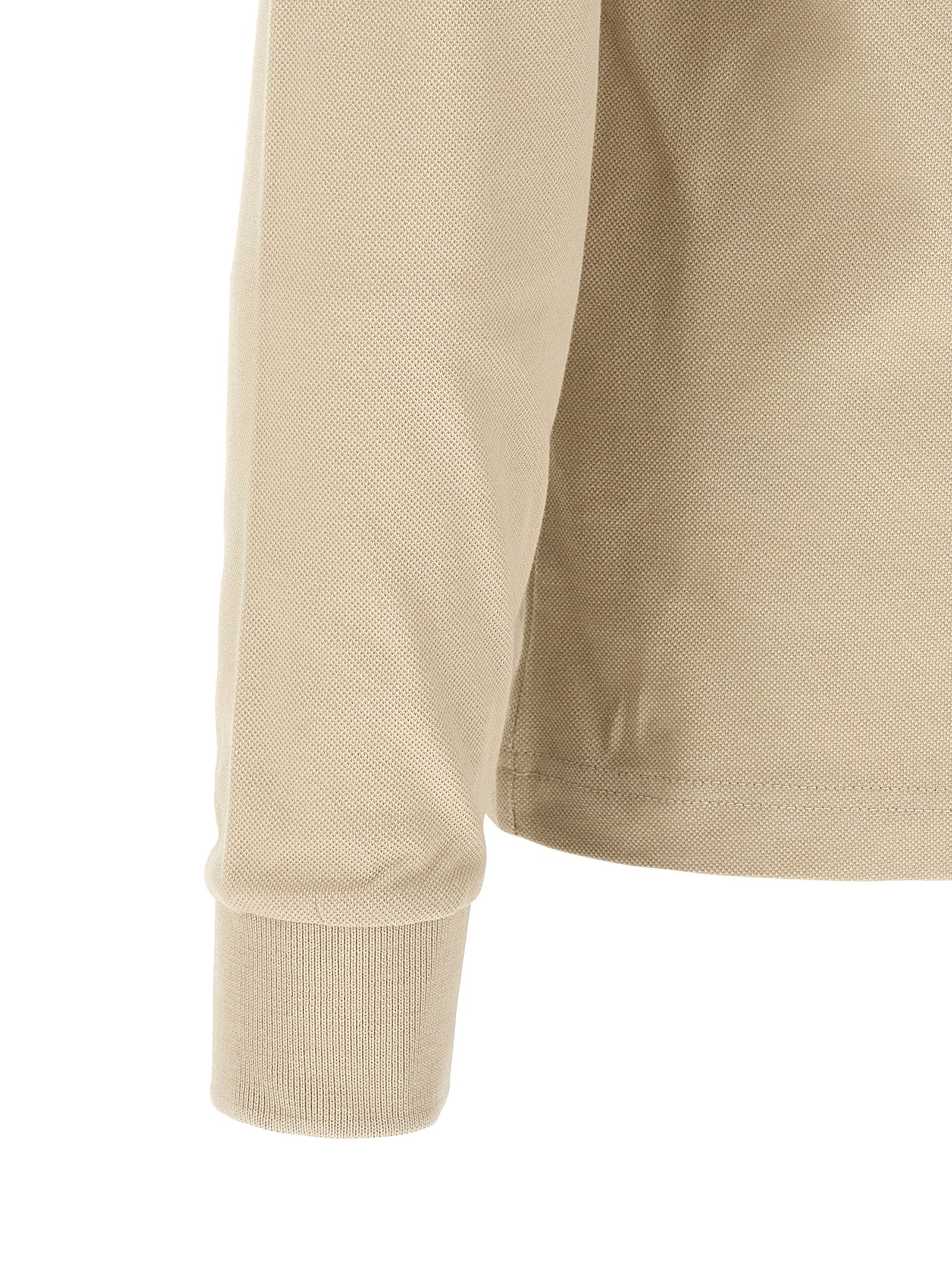 Chemise polo beige en coton de la marque Hugo Boss, vue de face avec col et boutons visibles.