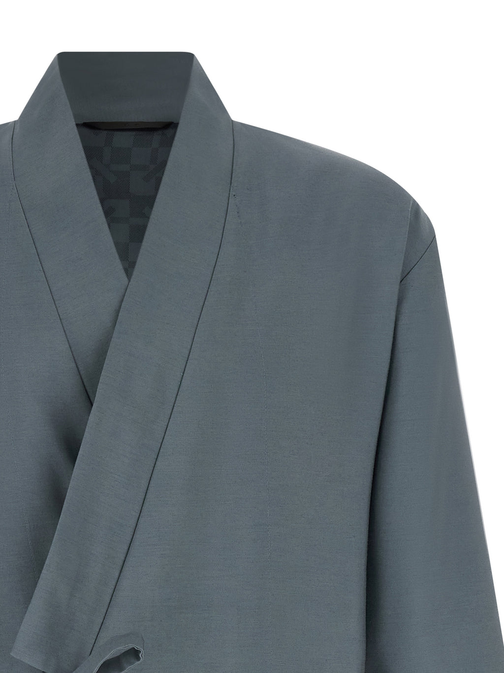 Blazer en laine gris de la marque Kenzo, veste élégante avec col et boutons, portée sur un fond neutre.