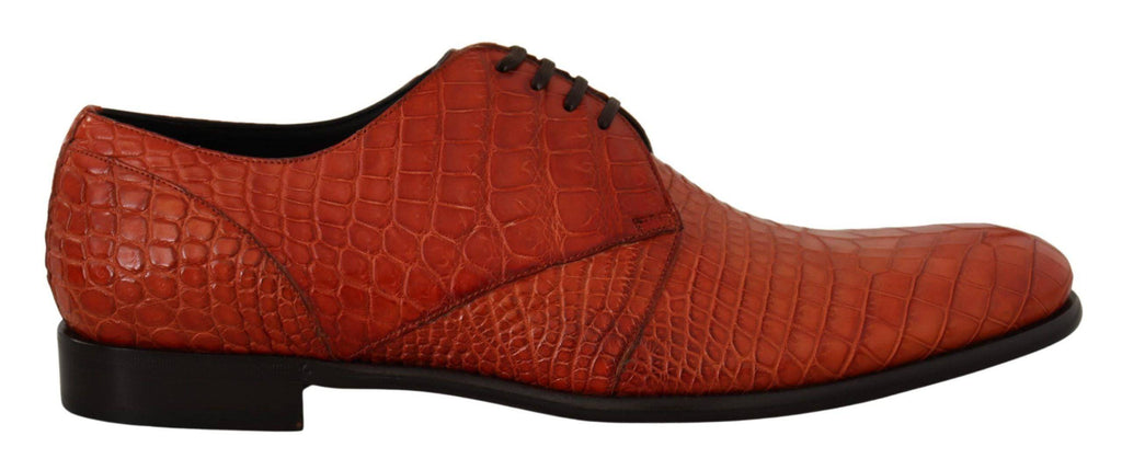 Chaussures Derby en cuir exotique orange de Dolce & Gabbana, élégantes et sophistiquées, vues de face avec détails de la texture.