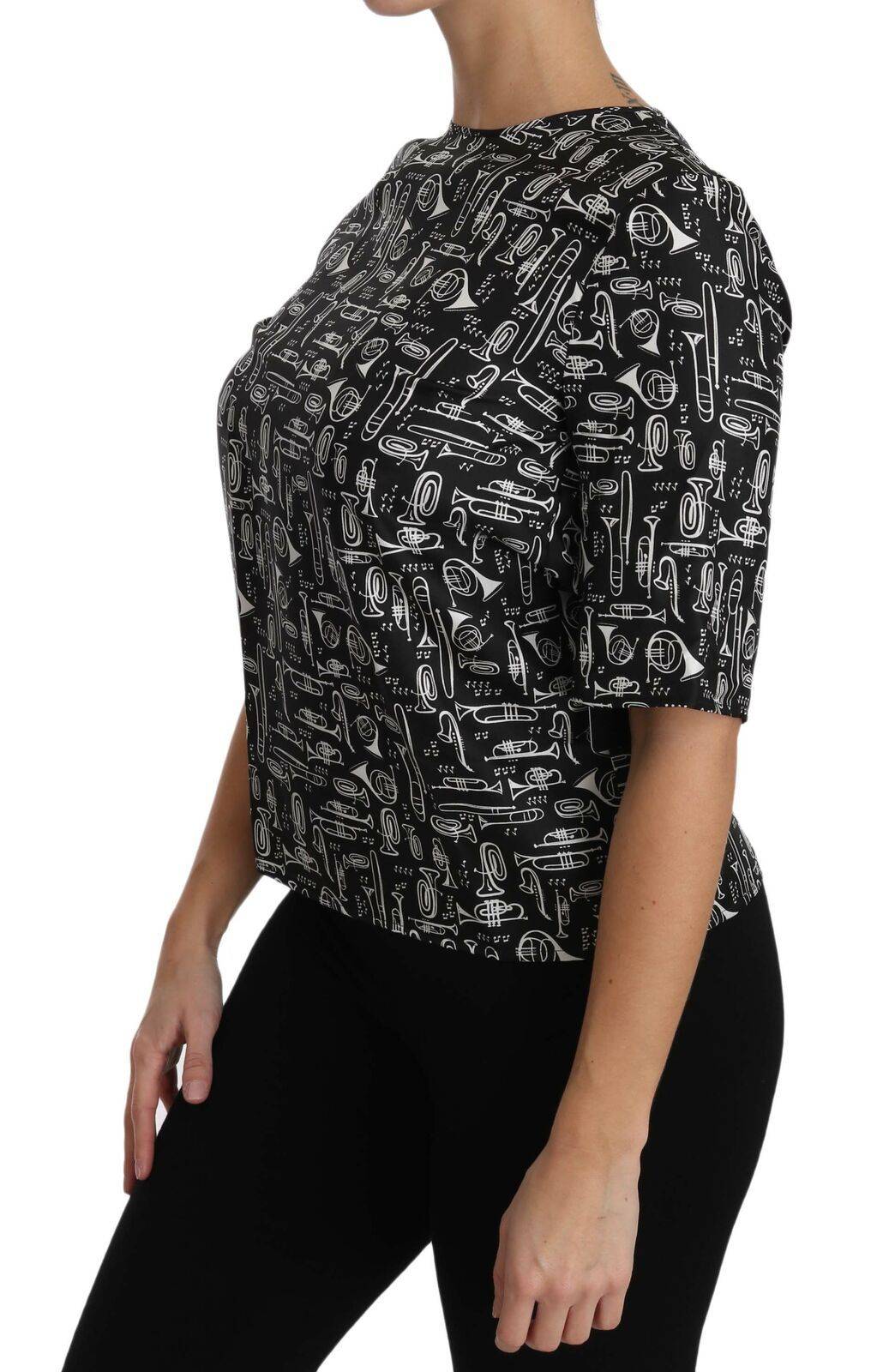 Blouse en soie noire Dolce & Gabbana avec imprimé instruments de musique, style élégant et sophistiqué.