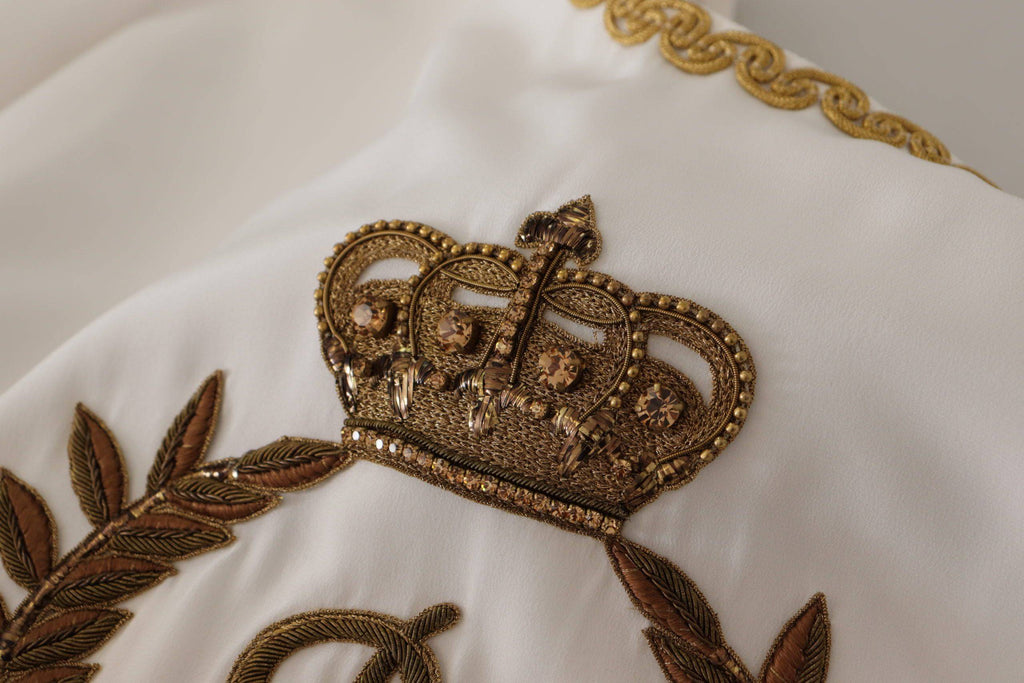 Blouse en soie blanche Dolce & Gabbana avec ornement DG, couronne en cristal, style élégant et sophistiqué.