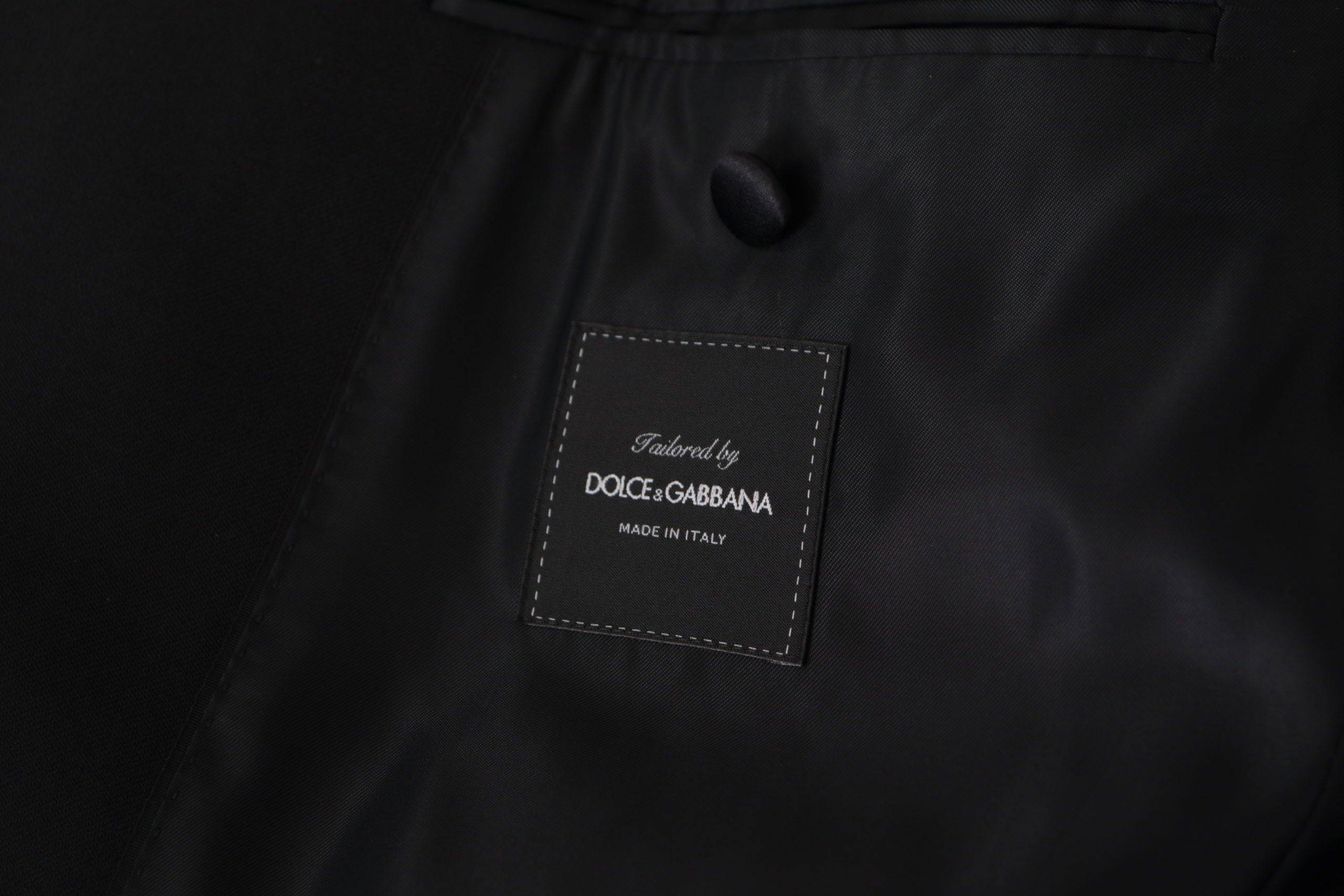 Veste blazer Dolce & Gabbana noire à double boutonnage, style élégant avec col cranté et poches latérales.