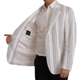 Blazer blanc à rayures en coton Dolce & Gabbana, coupe simple boutonnage croisé, style élégant et sophistiqué.