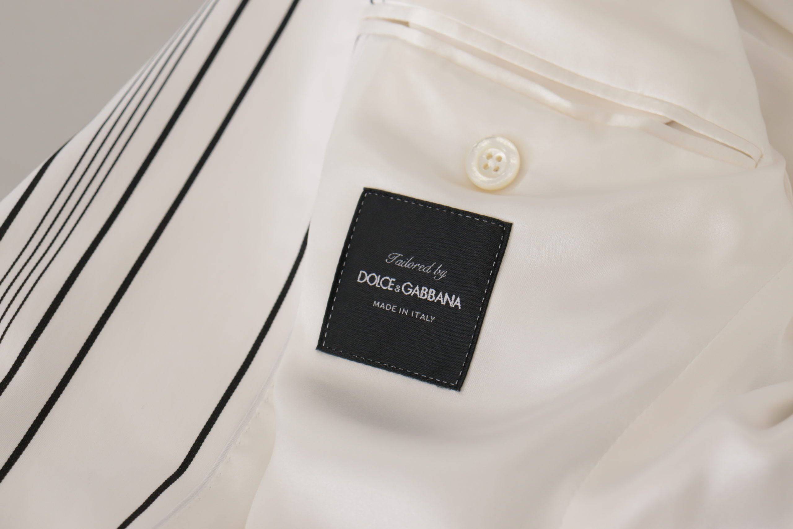 Blazer blanc à rayures en coton Dolce & Gabbana, classique et élégant, à coupe croisée simple, posé sur un mannequin.