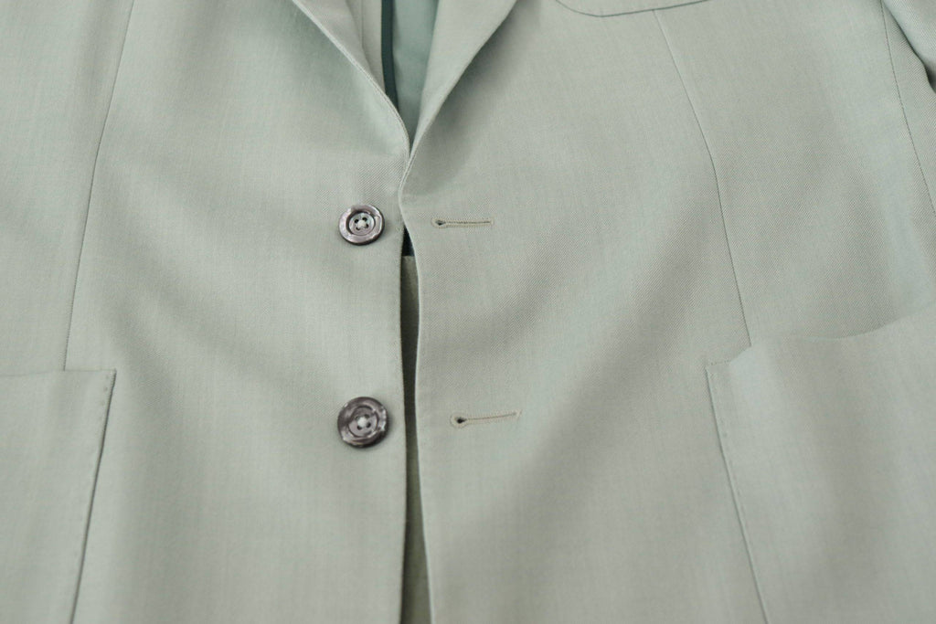 Veste blazer en cachemire vert Dolce & Gabbana, élégante et sophistiquée, visible avec détails de couture raffinés.