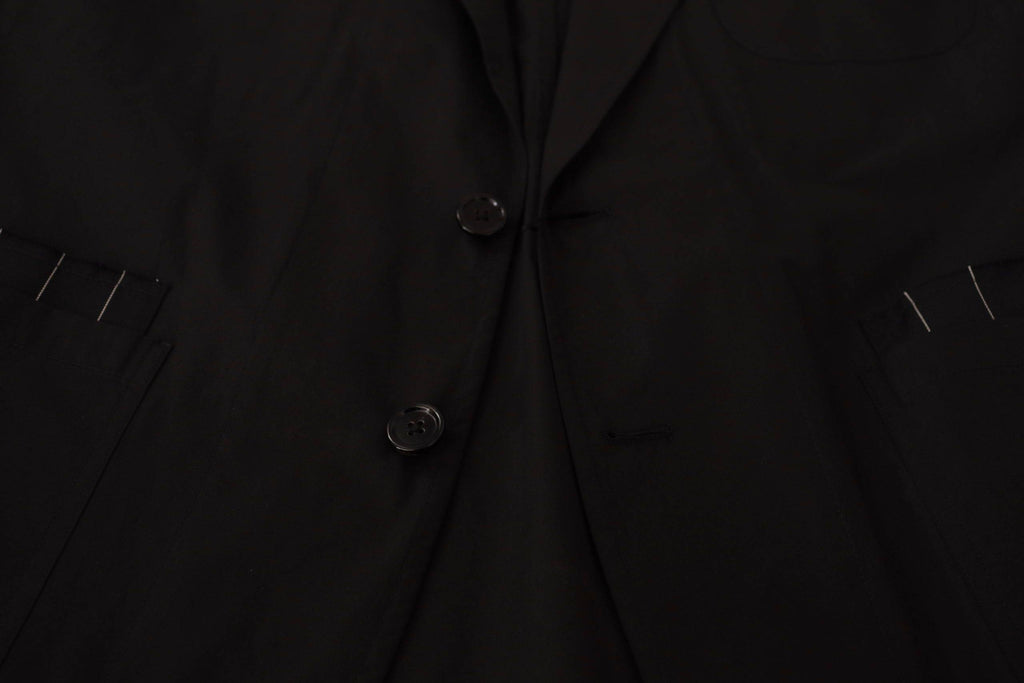 Veste blazer en coton noir Dolce & Gabbana à boutons simple boutonnage, élégante et ajustée, portée sur un mannequin.