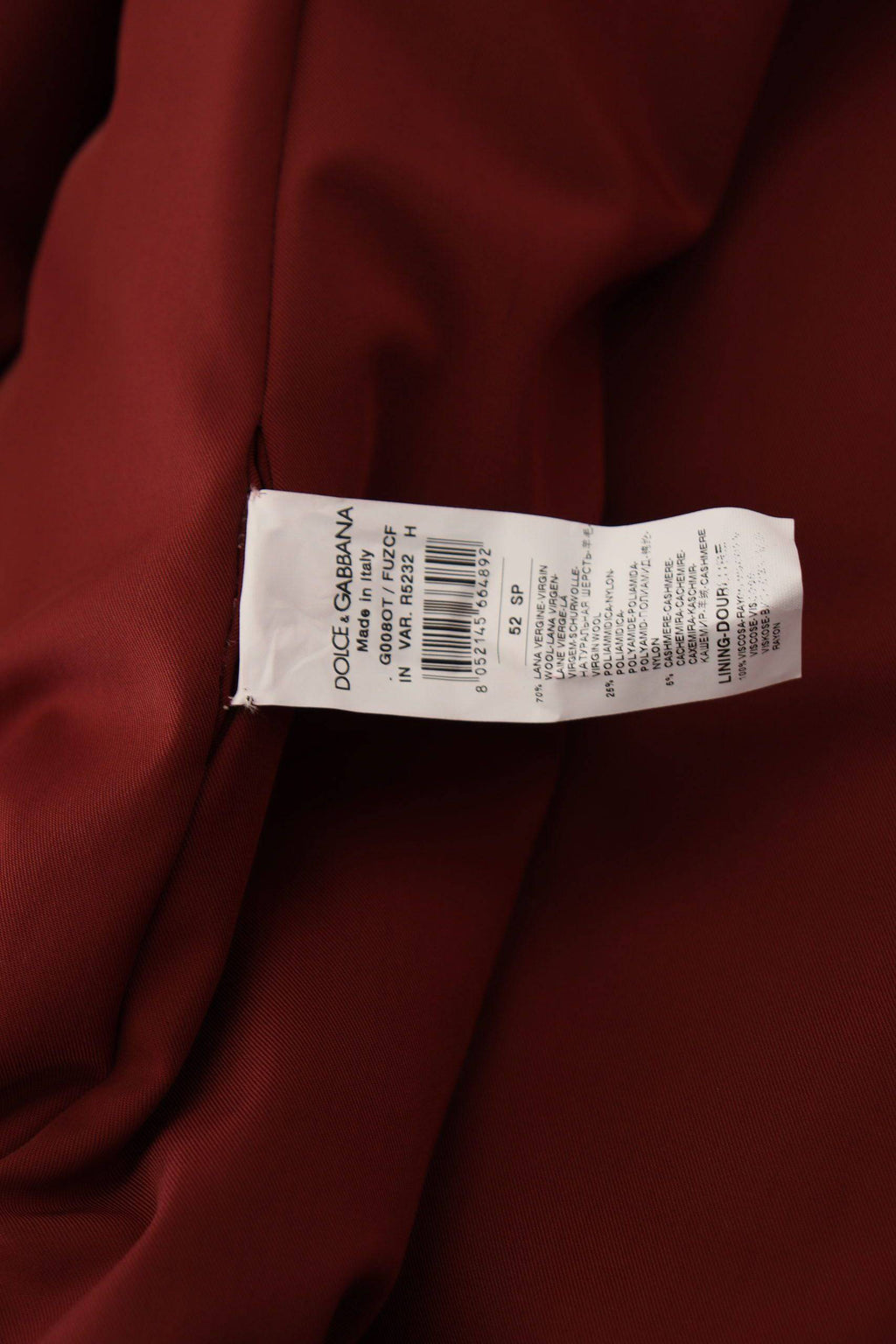 Manteau en laine rouge Dolce & Gabbana à double boutonnage, veste élégante avec col et poches visibles.