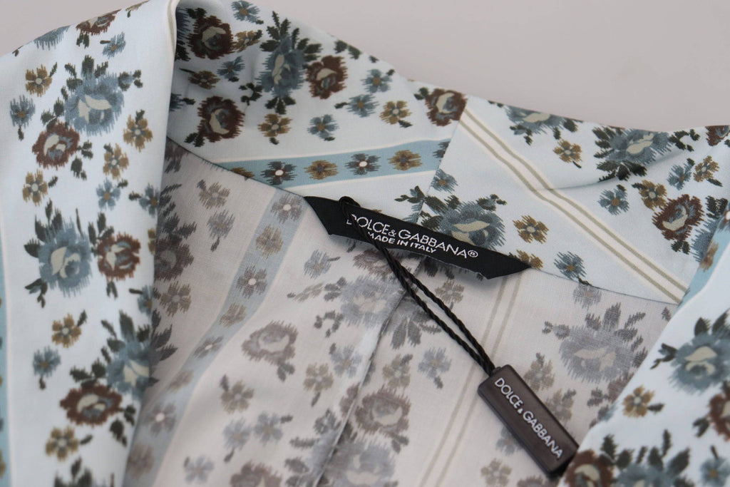 Robe-coat en coton bleu à fleurs Dolce & Gabbana, vêtement ample avec motif floral élégant et détails sophistiqués.