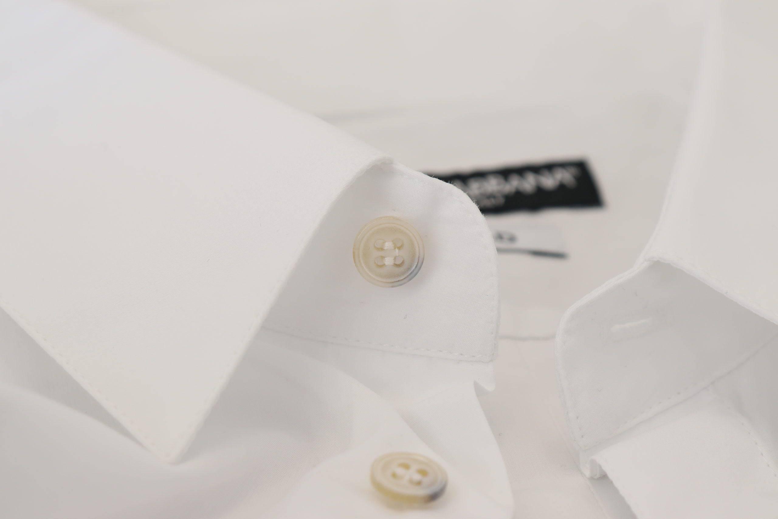 Chemise formelle blanche Dolce & Gabbana en coton avec motif de paon doré et détails élégants.
