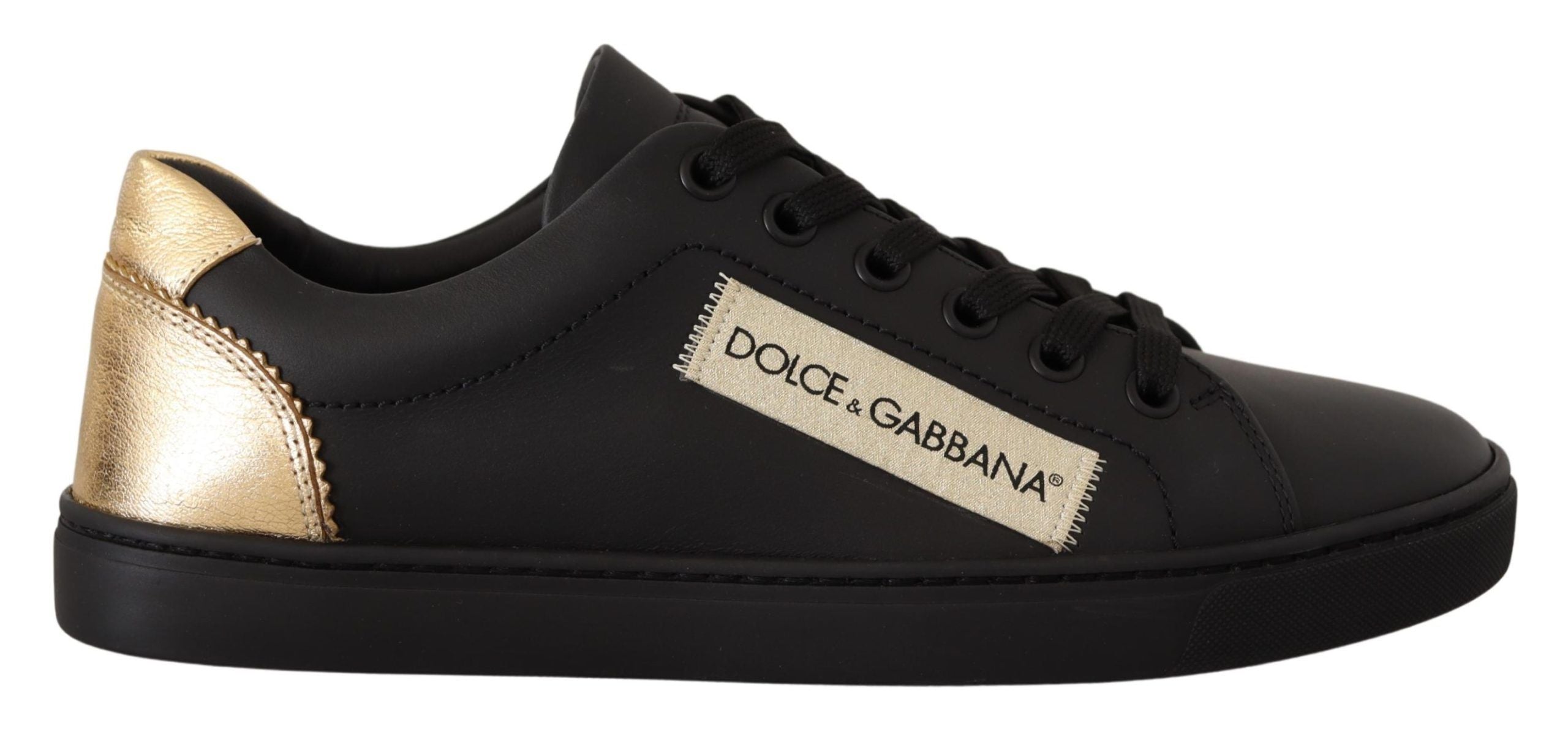 Sneakers bass en cuir noir et or Dolce & Gabbana pour femmes, avec logo et semelle blanche dans une image en gros plan.
