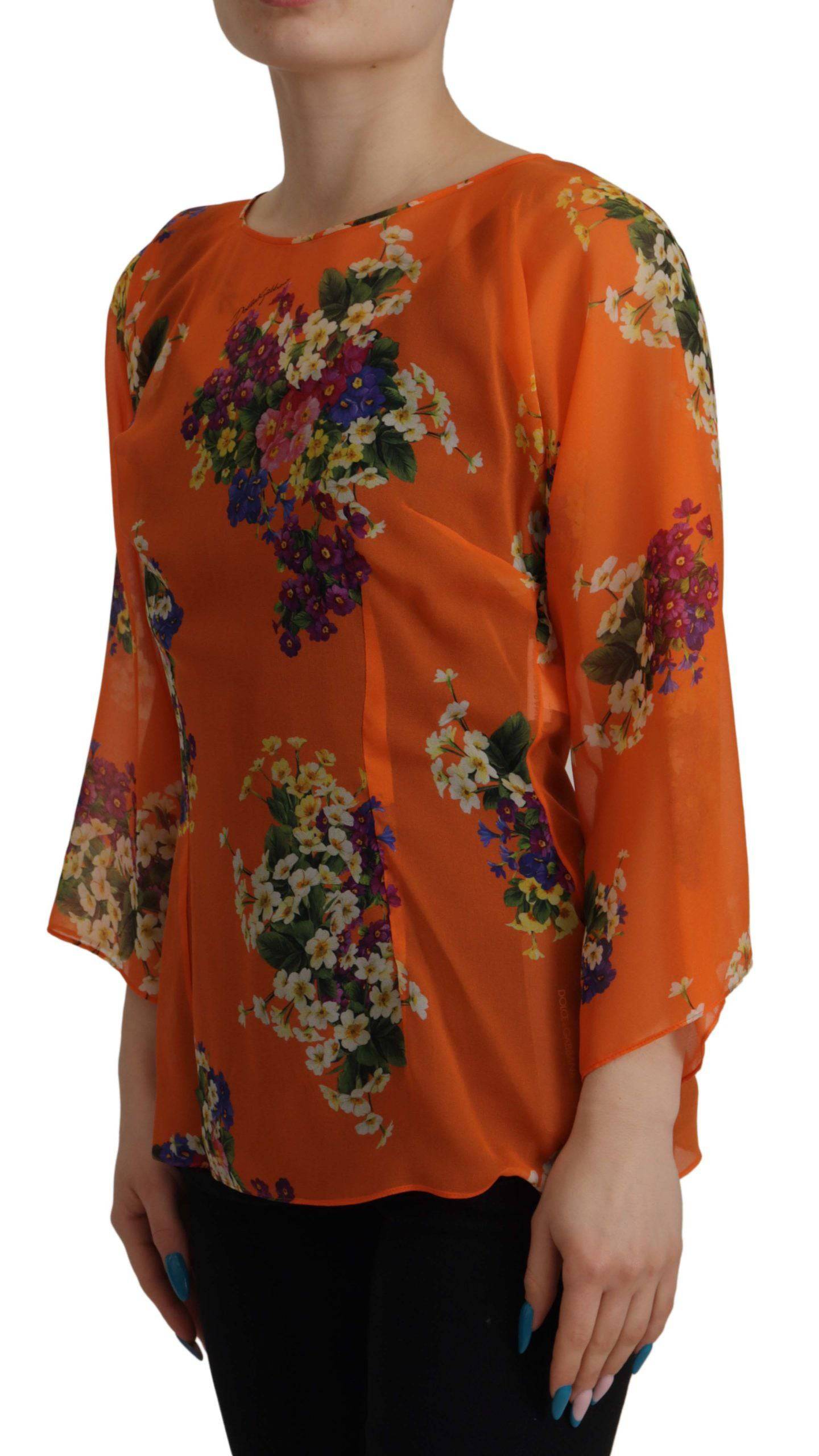 Chemisier à manches longues Dolce & Gabbana à imprimé floral orange, tissu léger et élégant, porté sur un mannequin.