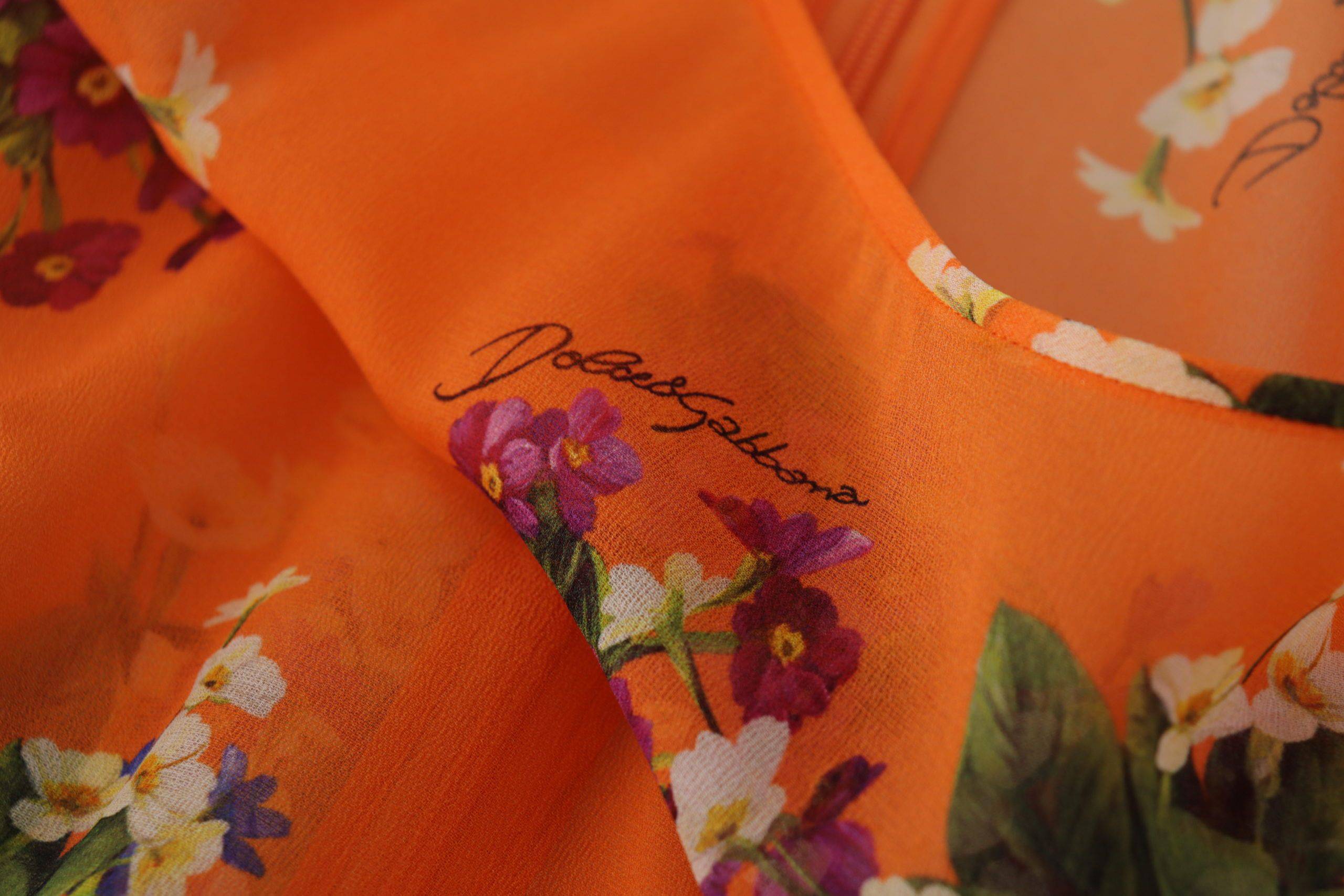 Chemisier à manches longues Dolce & Gabbana à imprimé floral orange, style élégant et féminin.