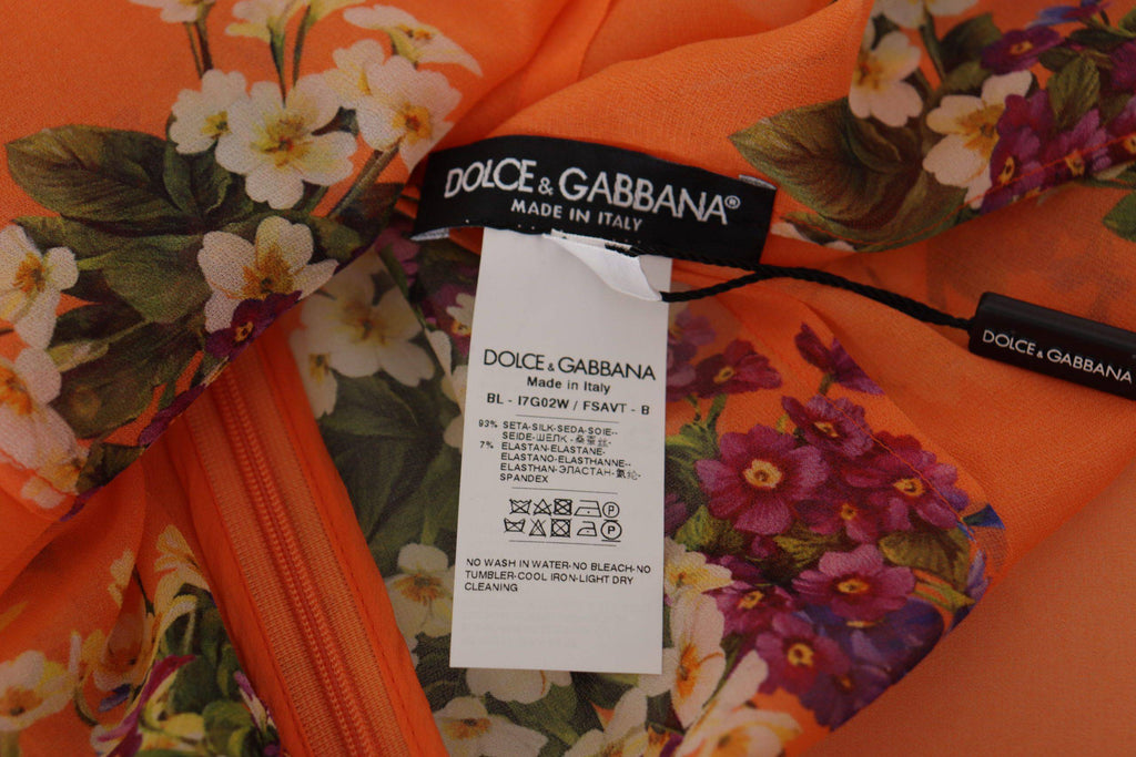 Blouse à manches longues Dolce & Gabbana avec imprimé floral orange, tissu léger et élégant.