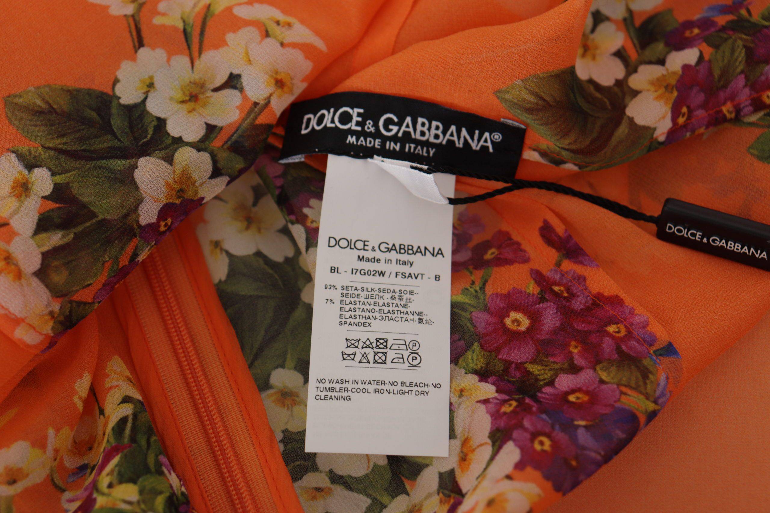 Blouse à manches longues Dolce & Gabbana avec imprimé floral orange, tissu léger et élégant.