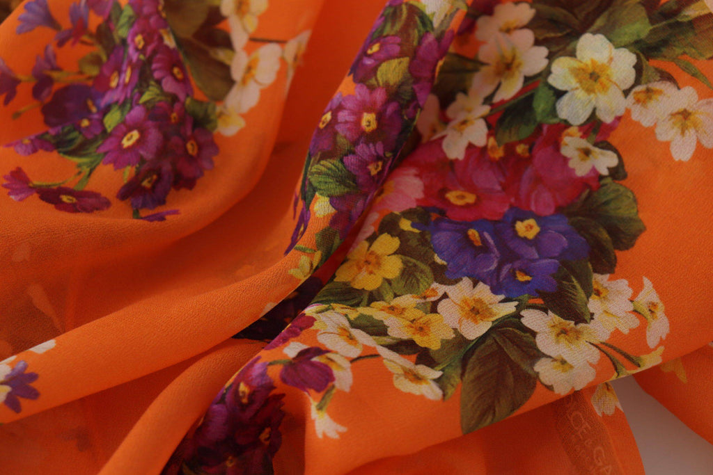 Chemise longue à manches longues Dolce & Gabbana avec imprimé floral orange, tissu léger et style élégant.