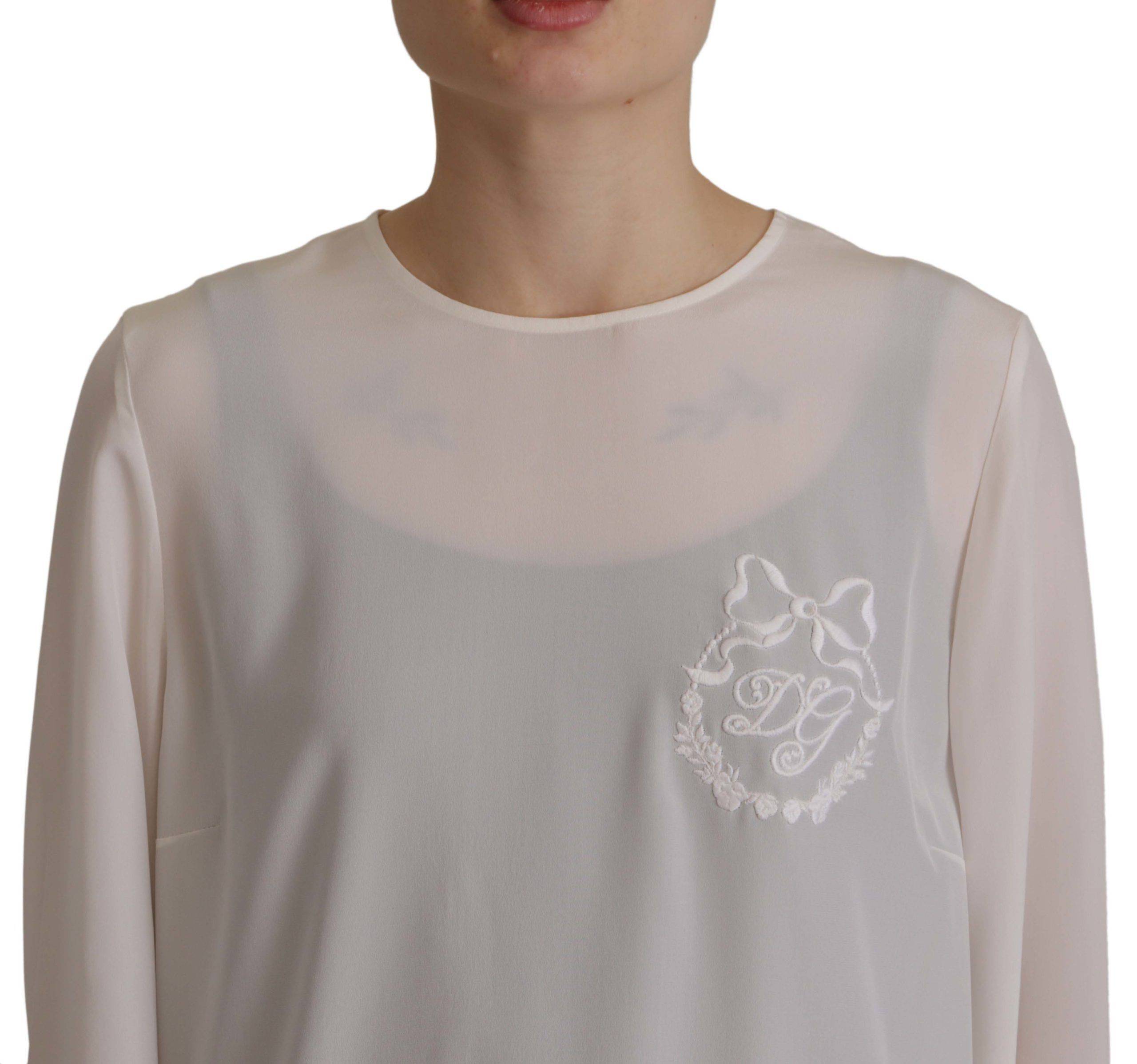Chemisier Dolce & Gabbana en soie blanche avec logo DG brodé, manches longues et style élégant.