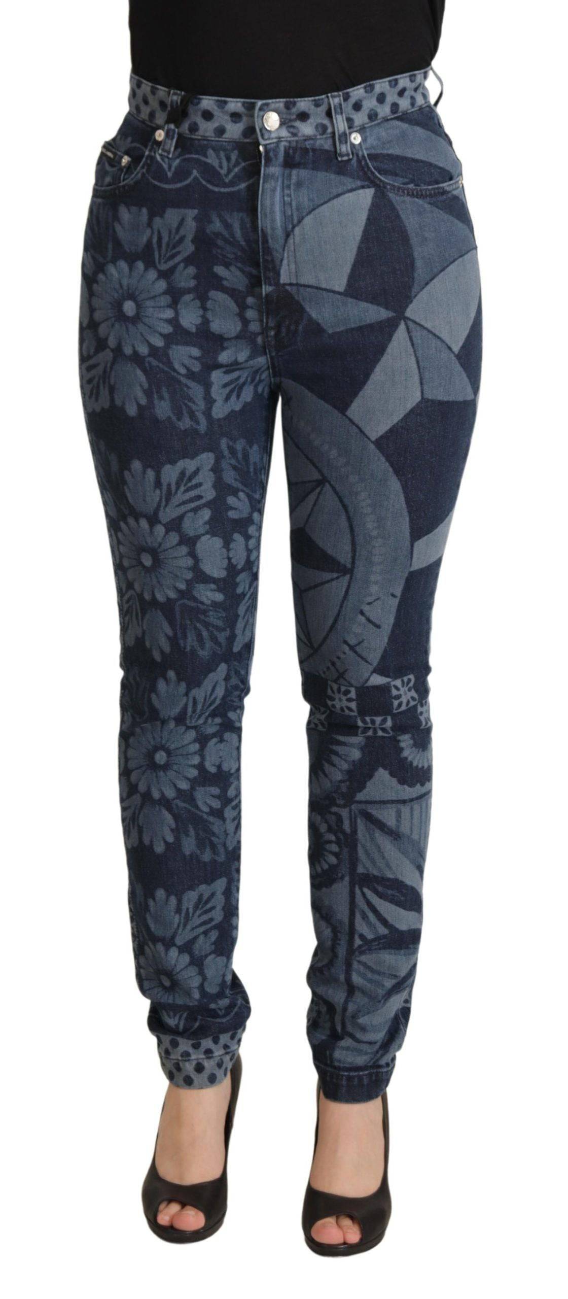 Jeans en denim skinny à taille haute Dolce & Gabbana bleu avec motifs floraux, visibles en détail sur l'image.