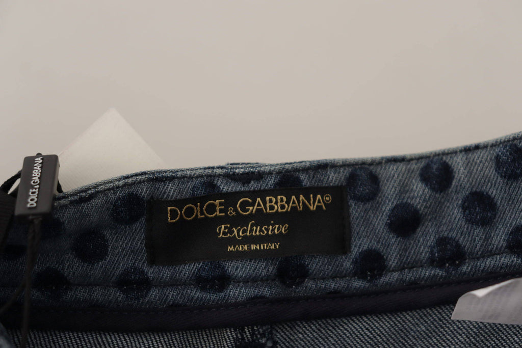 Jeans skinny en denim bleu à taille haute Dolce & Gabbana avec motifs floraux, visibles sur l'image.