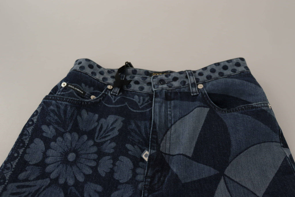 Jean skinny en denim bleu à taille haute avec motif floral, Dolce & Gabbana, visible en détail sur l'image.