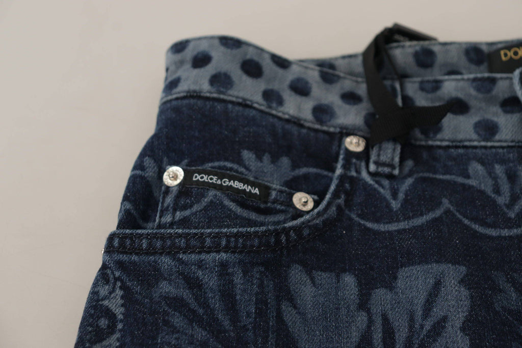 Jeans slim taille haute en denim bleu à fleurs Dolce & Gabbana, coupe skinny, visible sur l'image.