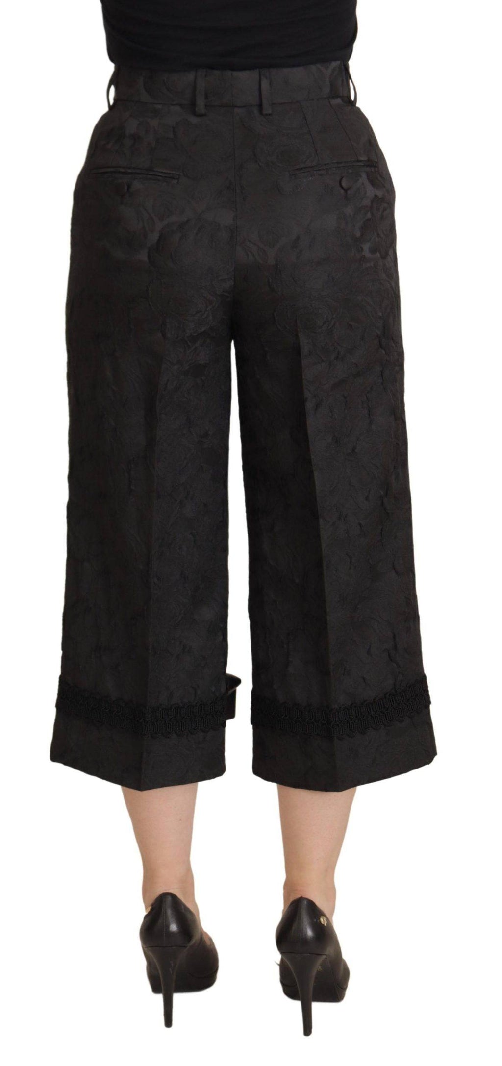 Pantalon noir en brocart Dolce & Gabbana à taille haute et coupe cropped, élégant et sophistiqué.