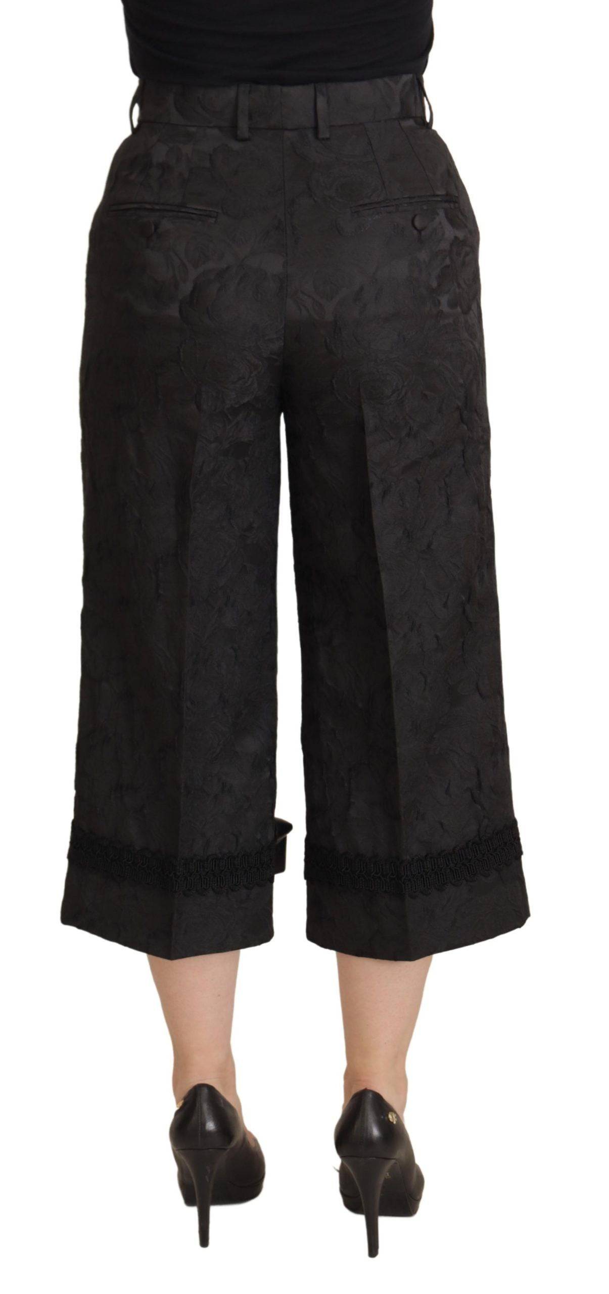 Pantalon noir en brocart Dolce & Gabbana à taille haute et coupe cropped, élégant et sophistiqué.