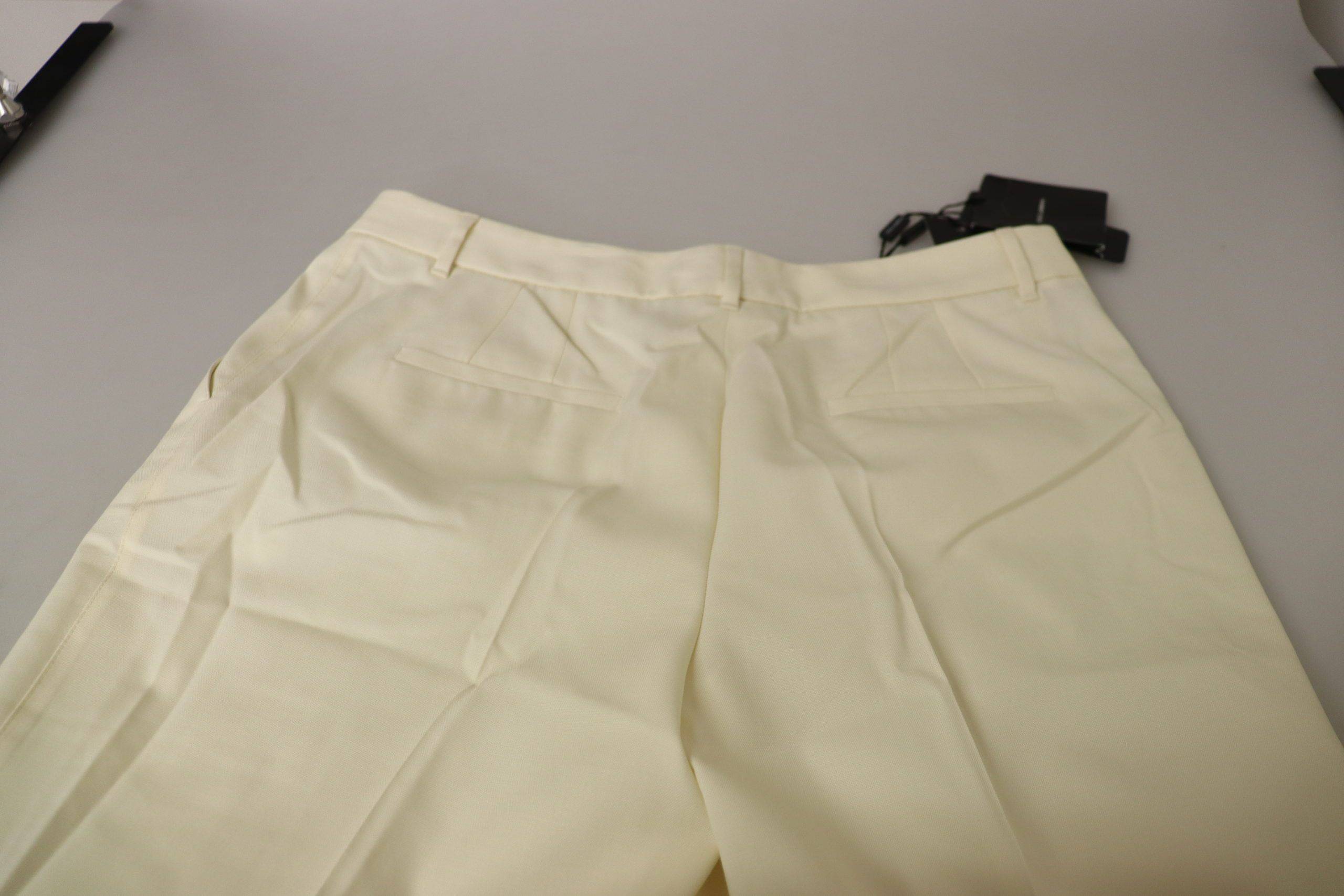 Pantalon blanc taille haute Dolce & Gabbana avec revers plissés et coupe cropped, en tissu léger et élégant.