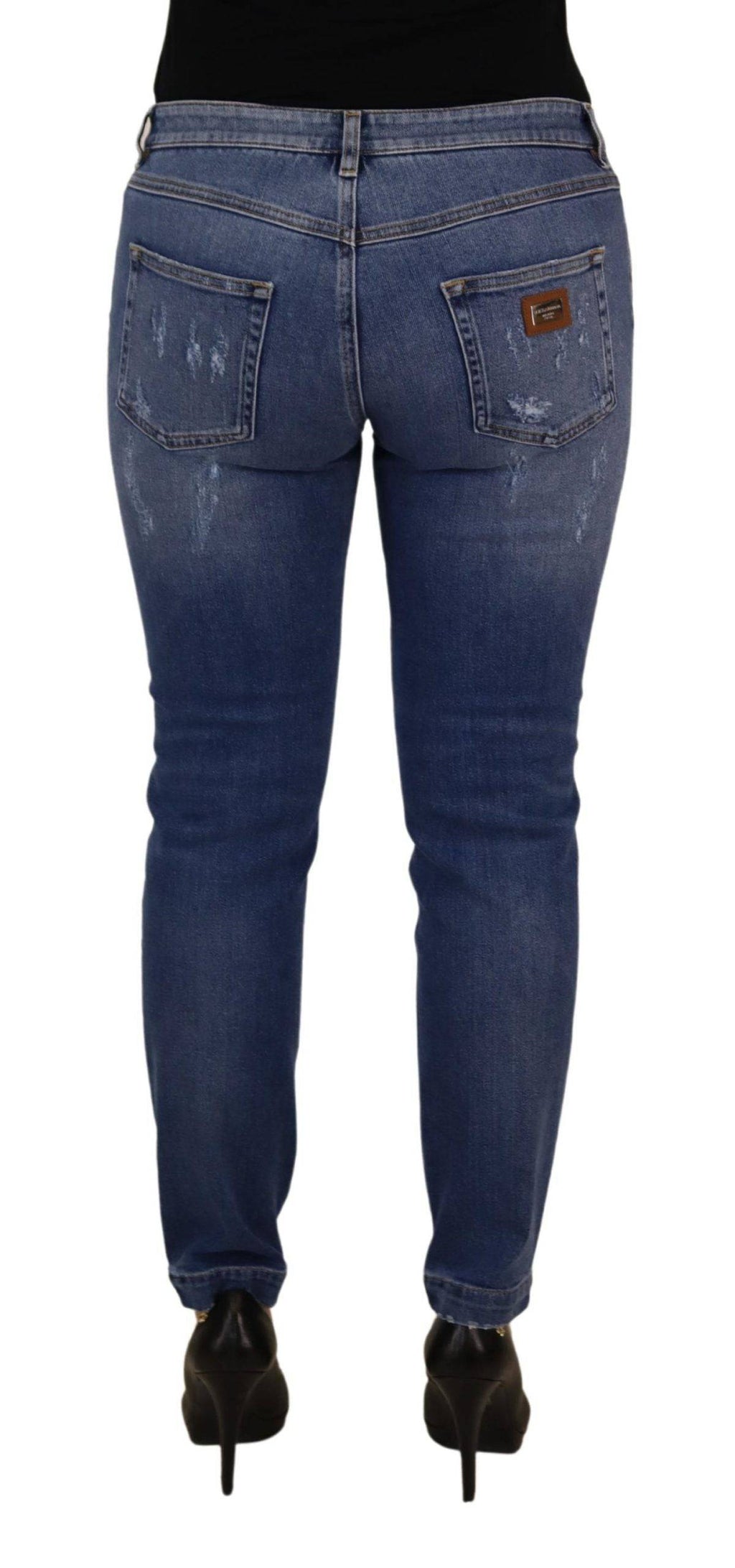 Jeans skinny en denim bleu délavé Dolce & Gabbana à taille basse, coupe ajustée et détails classiques.