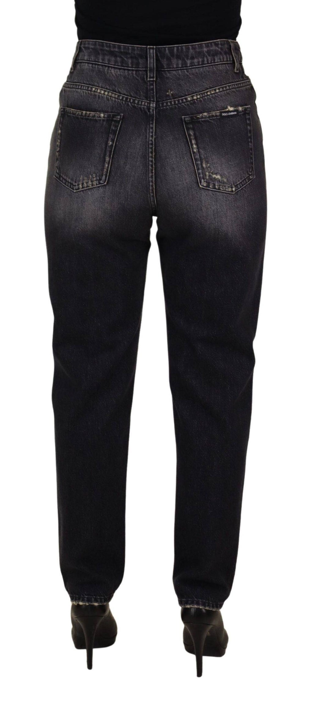 Jeans en denim noir délavé et déchiré à taille haute de Dolce & Gabbana, style décontracté et tendance visible sur l’image.