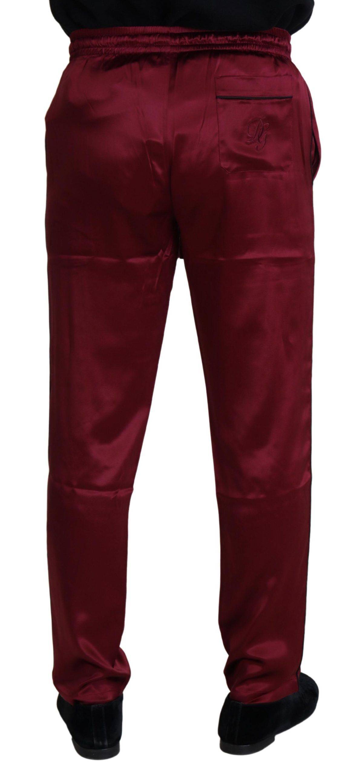Pantalons de détente en soie bordeaux Dolce & Gabbana, style lounge, avec ceinture élastique et coupe confortable.
