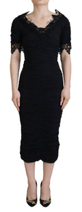 Robe noire Dolce & Gabbana en dentelle et soie, coupe midi et ajustée, vêtement élégant et féminin.
