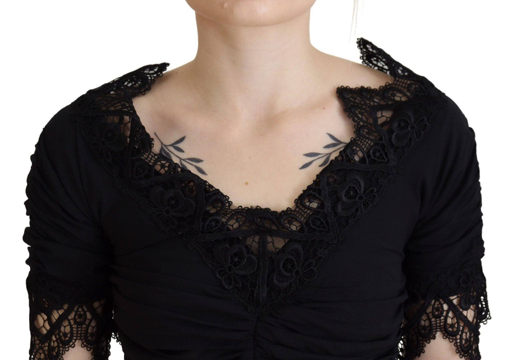 Robe noire Dolce & Gabbana en dentelle et soie, coupe midi moulante et élégante, pour une silhouette sophistiquée.