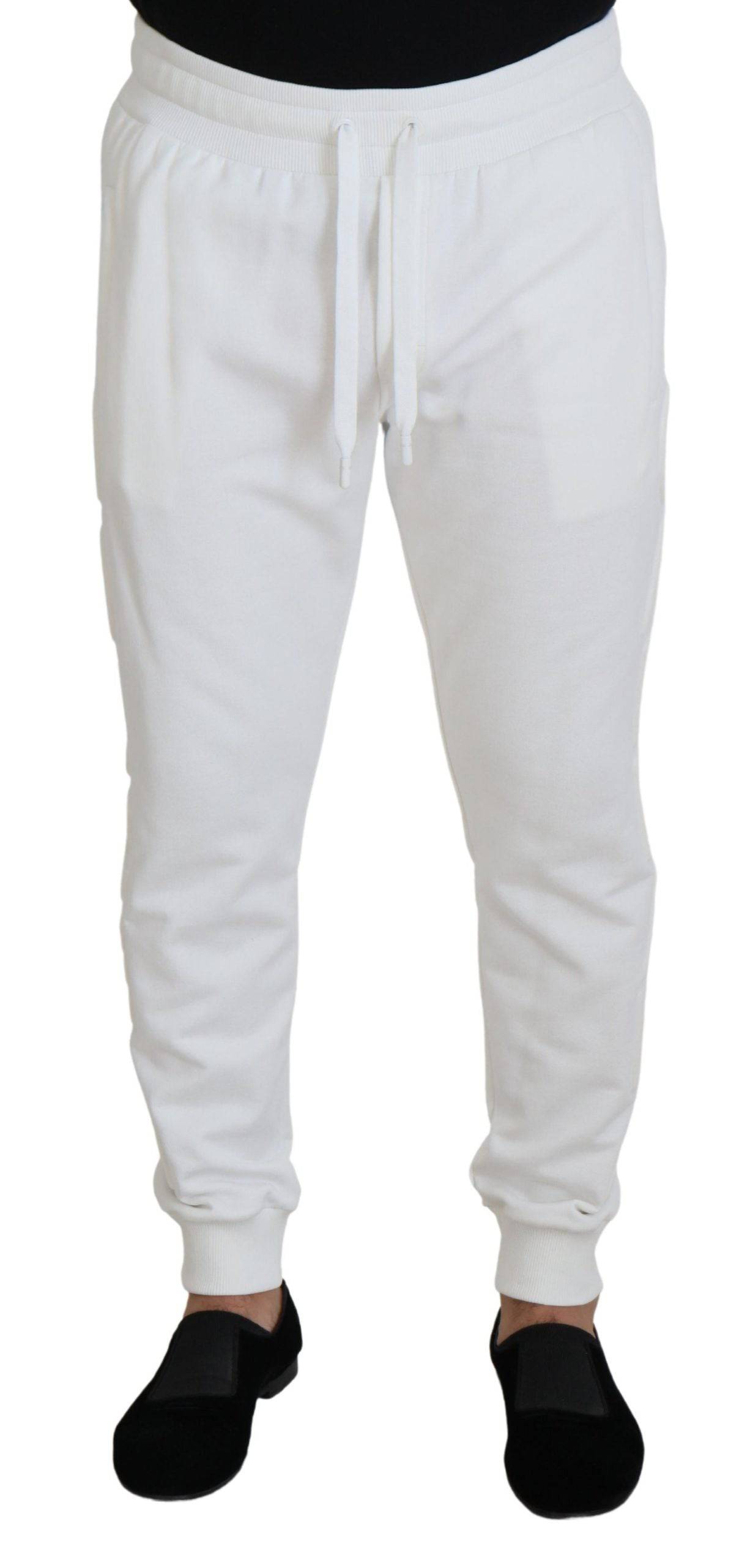 Pantalon de sport blanc Dolce & Gabbana en coton avec logo, style décontracté et confortable, visible en détail dans l'image.