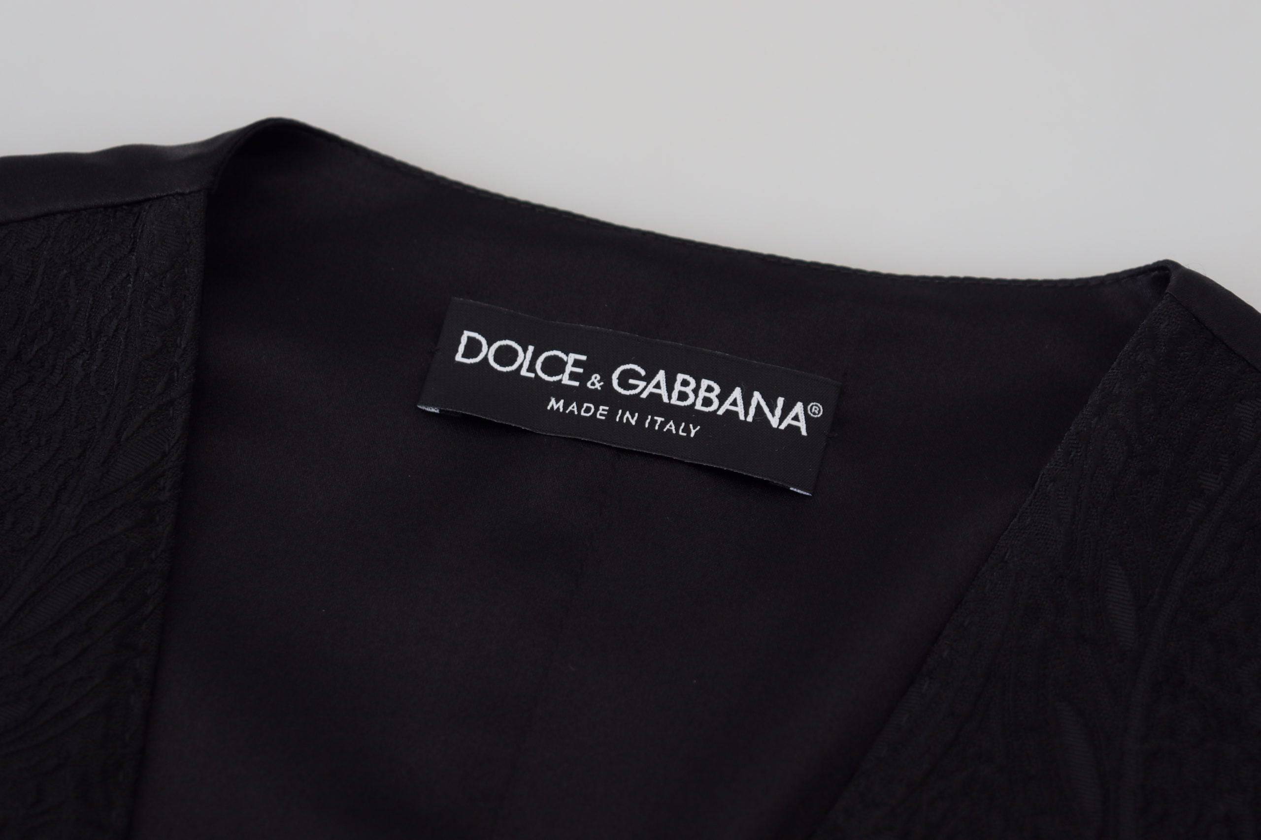 Top sans manches en brocart noir Dolce & Gabbana, veste avec boutons élégants et style sophistiqué.